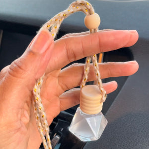 Hand holding essential oil car diffuser